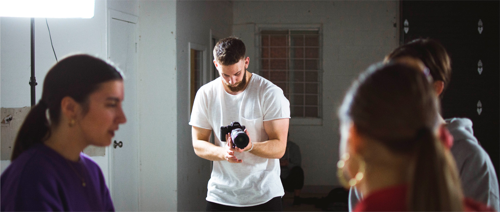 Man filming a group of people